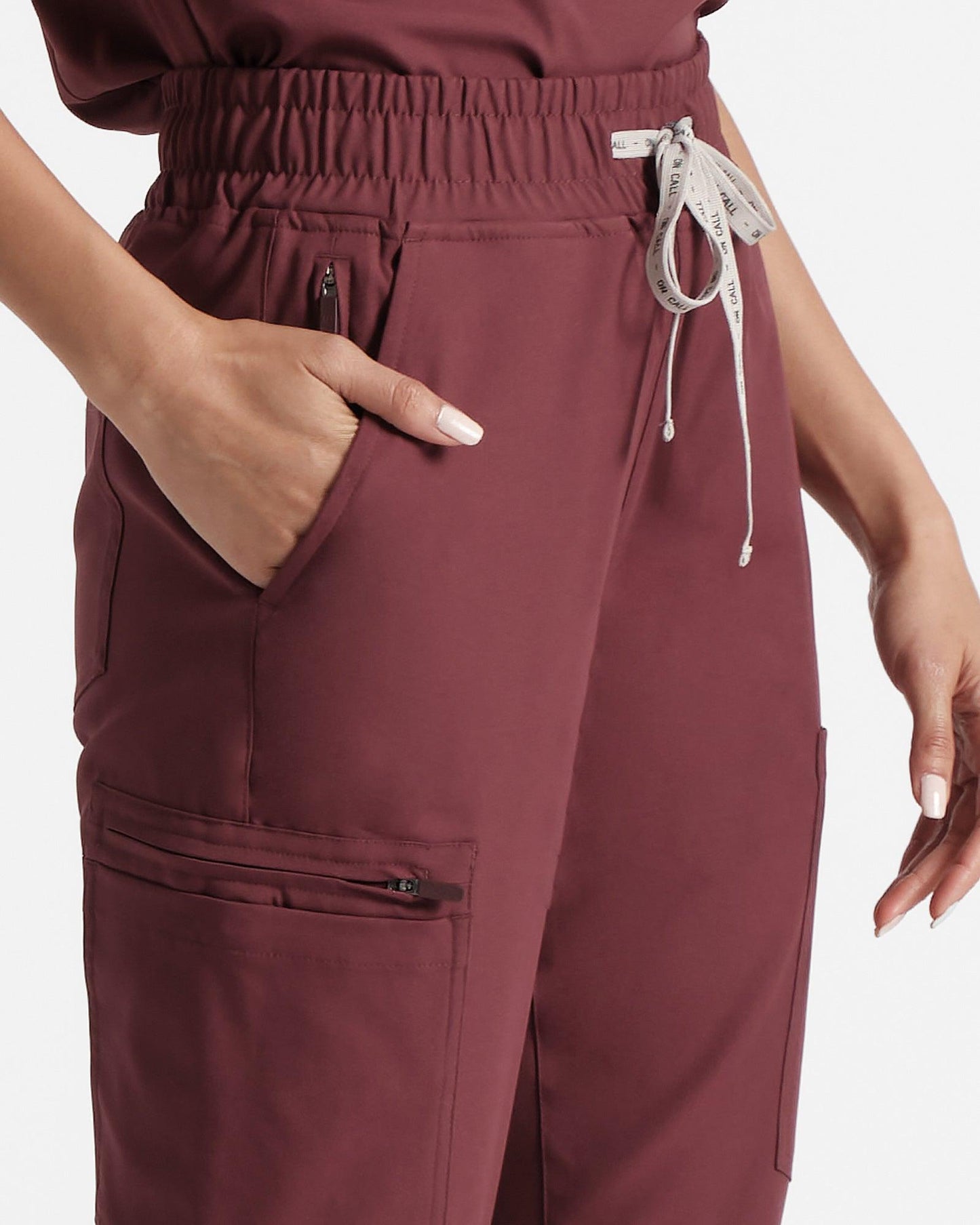 Close up of side pockets on women's jogger cargo scrub in heme red