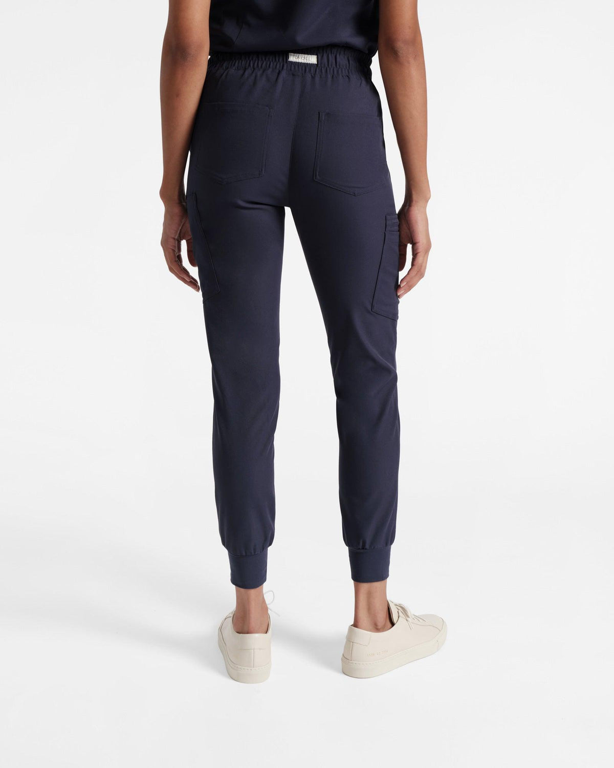 Back side view of woman in cargo jogger scrub pants with two back pockets.