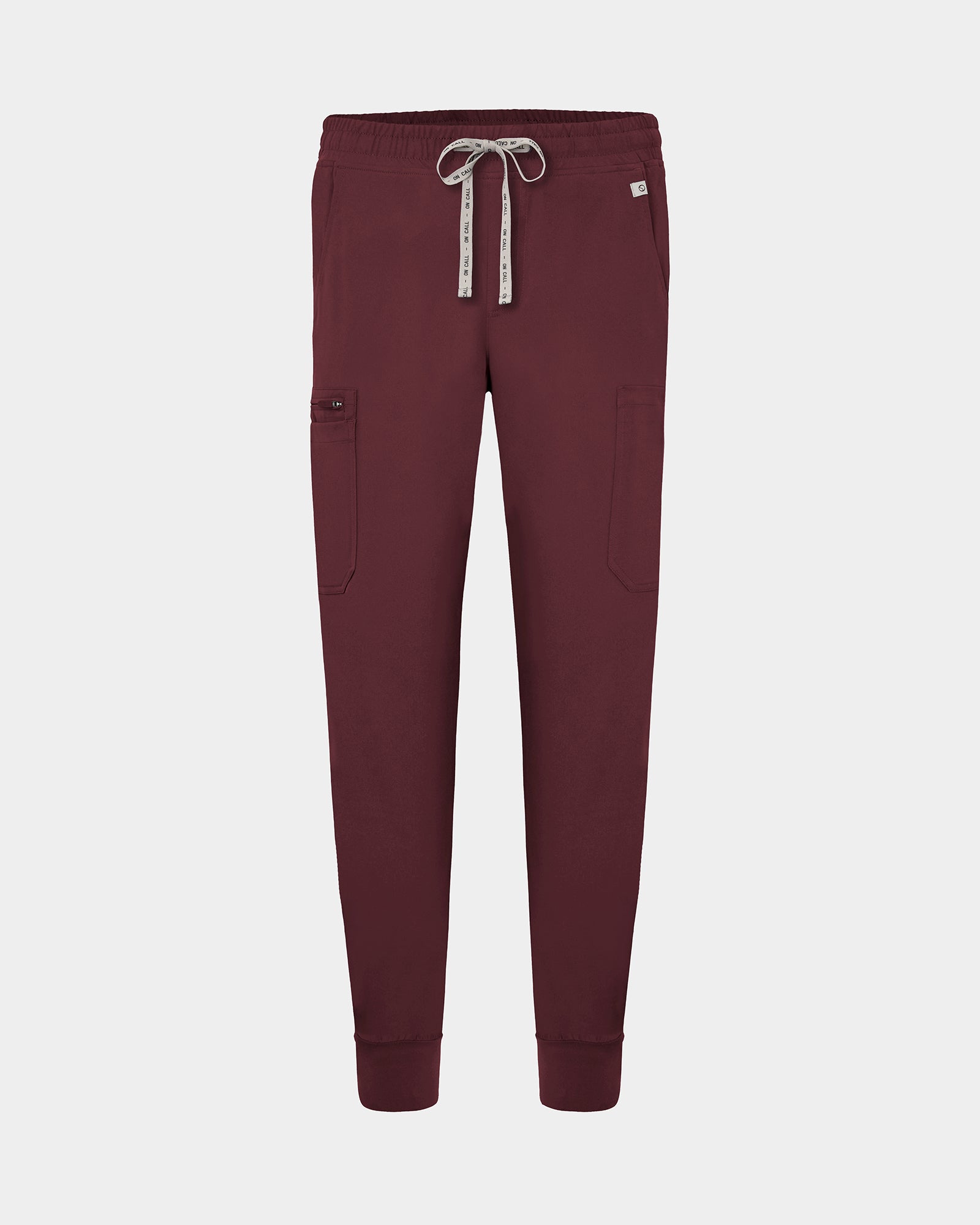 Heme red cargo jogger scrub pants with a logo drawstring, small logo label on the hip pocket, and ankle cuffs.