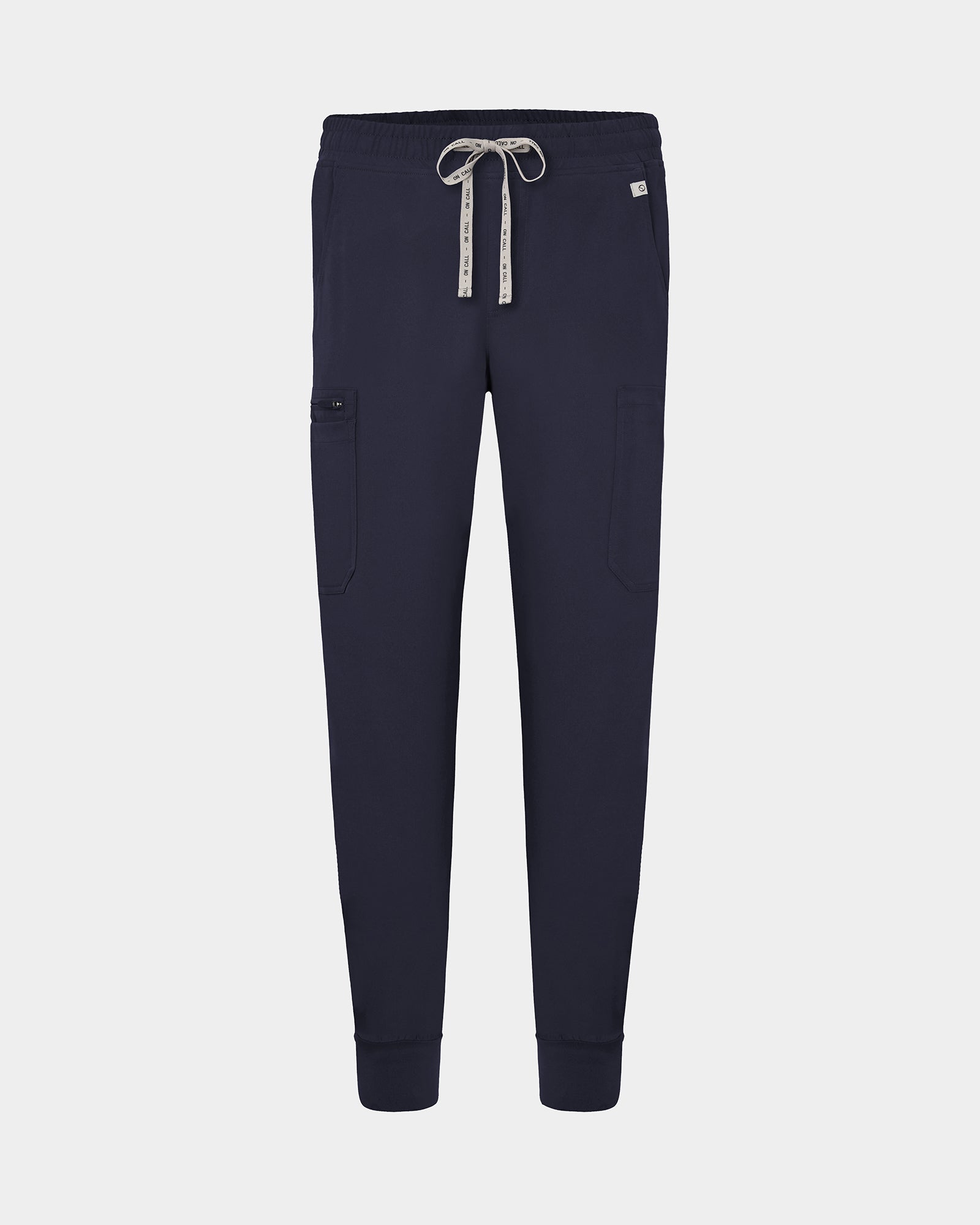 Navy cargo jogger scrub pants with a logo drawstring, small logo label on the hip pocket, and ankle cuffs.