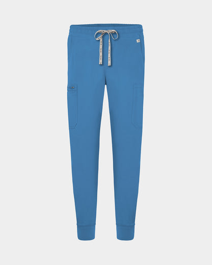 Bright blue scrub pants with a drawstring waist, side cargo pocket, and ribbed ankle cuffs, shown on a light gray background.