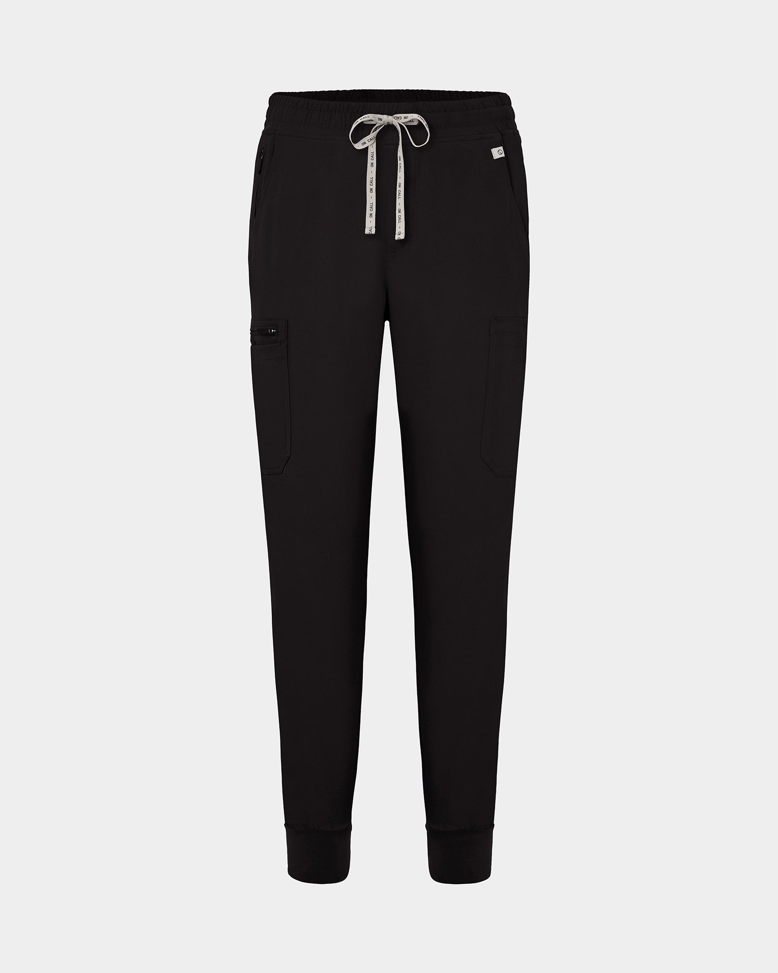 Black jogger-style scrub pants with a white drawstring, cargo pockets, and a small white logo on the upper right hip, shown against a light gray background.
