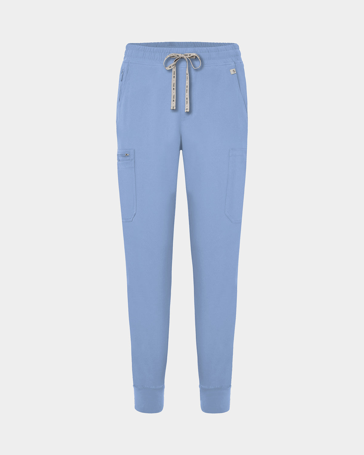 Light blue jogger-style scrub pants with a white drawstring, cargo pockets, and a small white logo on the upper right hip, shown against a light gray background.
