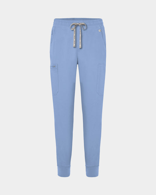 Light blue jogger-style scrub pants with a white drawstring, cargo pockets, and a small white logo on the upper right hip, shown against a light gray background.