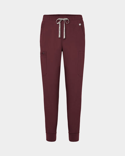 Dark heme red jogger-style scrub pants with a white drawstring, cargo pockets, and a small white logo on the upper right hip, shown against a light gray background.
