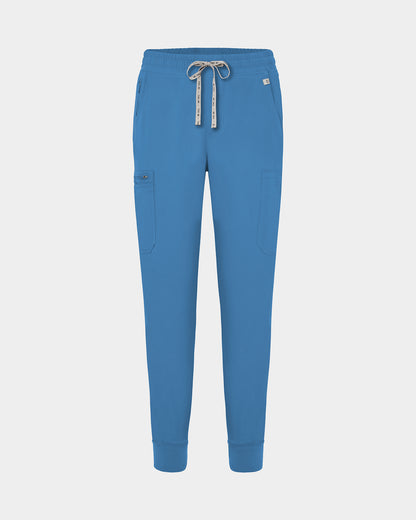 Bright blue jogger-style scrub pants with a white drawstring, cargo pockets, and a small white logo on the upper right hip, shown against a light gray background.
