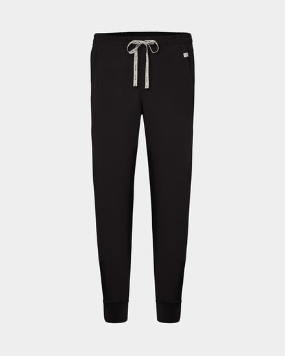Black jogger scrub pants with a white patterned drawstring and a small white brand tag on the right hip, shown against a light gray background.