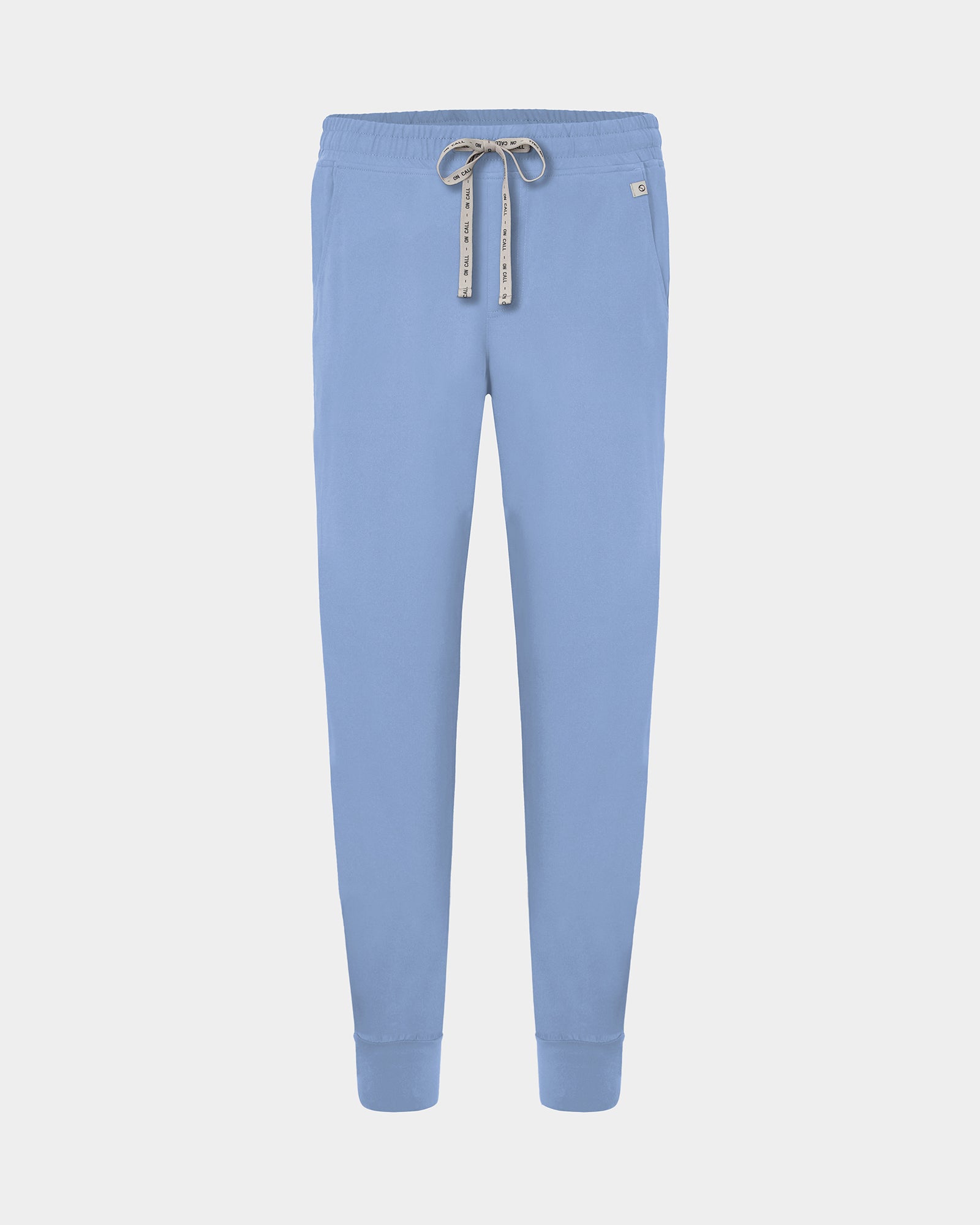 Light blue cargo jogger scrub pants with a logo drawstring, small logo label on the hip pocket, and ankle cuffs.
