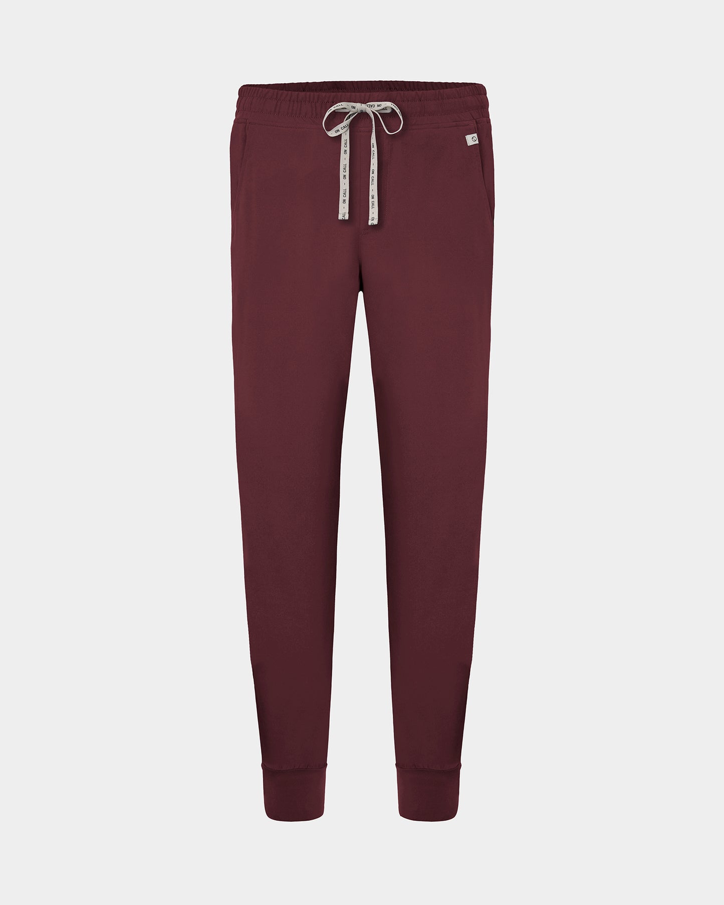 A pair of heme red jogger scrub pants with a logo drawstring, displayed on a light gray background.