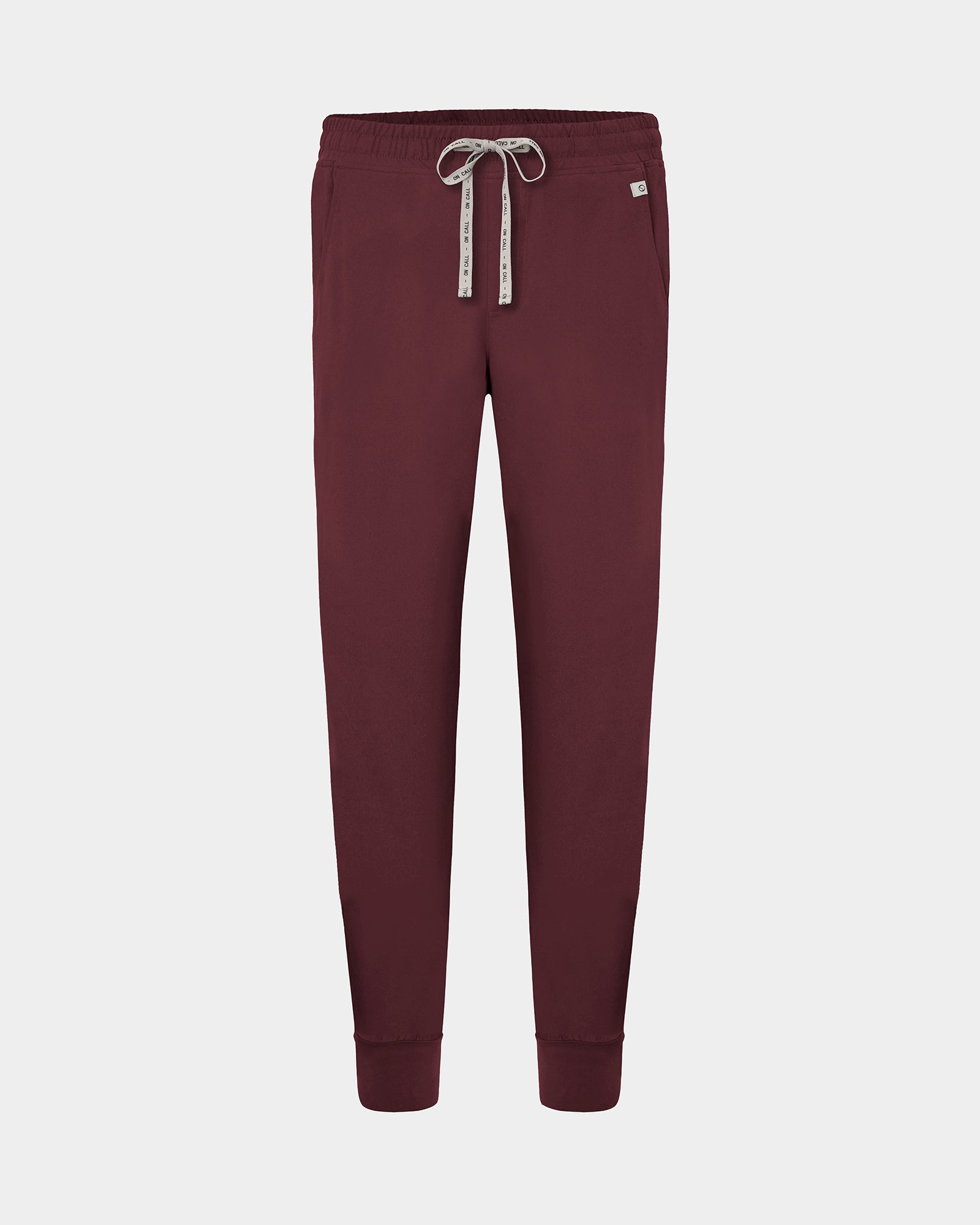 A pair of heme red jogger scrub pants with a logo drawstring, displayed on a light gray background.