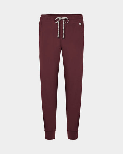 A pair of heme red jogger scrub pants with a logo drawstring, displayed on a light gray background.