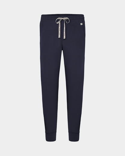 A pair of navy jogger pants with a logo drawstring, displayed on a light gray background.