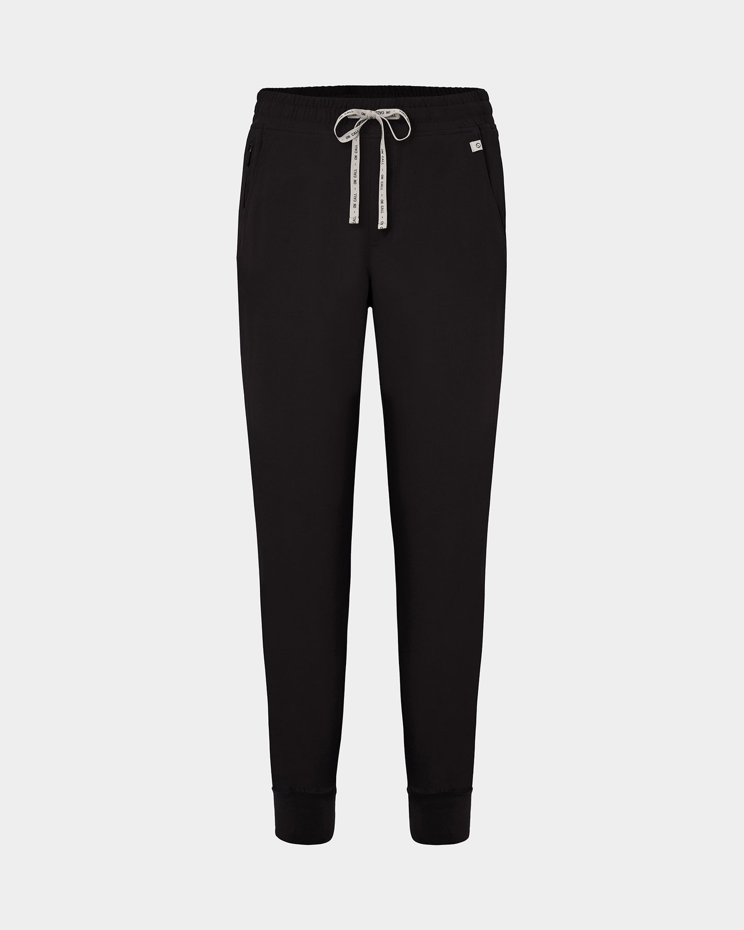 Black jogger scrub pants with a logo drawstring, ankle cuffs, and a small white logo on the left hip, shown against a light gray background.