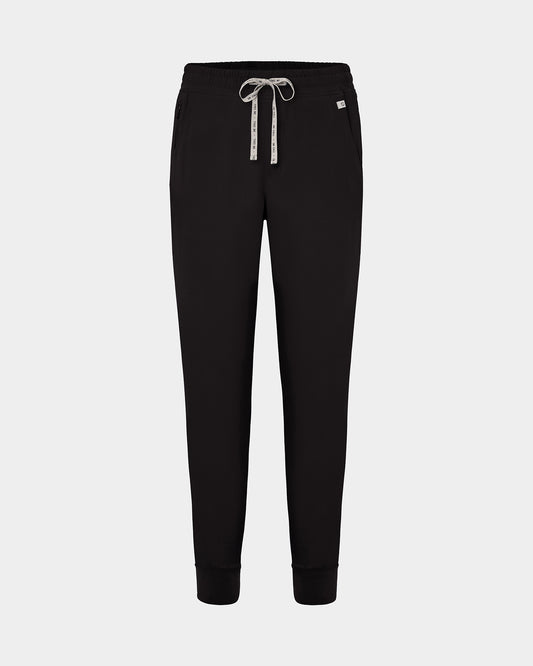 Black jogger scrub pants with a logo drawstring, ankle cuffs, and a small white logo on the left hip, shown against a light gray background.