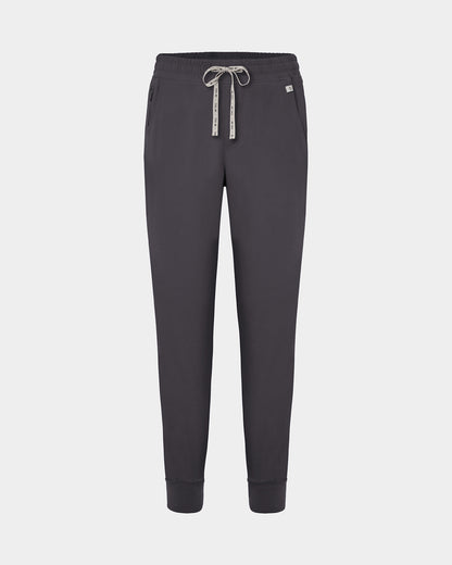 Dark grey jogger scrub pants with a logo drawstring, ankle cuffs, and a small white logo on the left hip, shown against a light gray background.