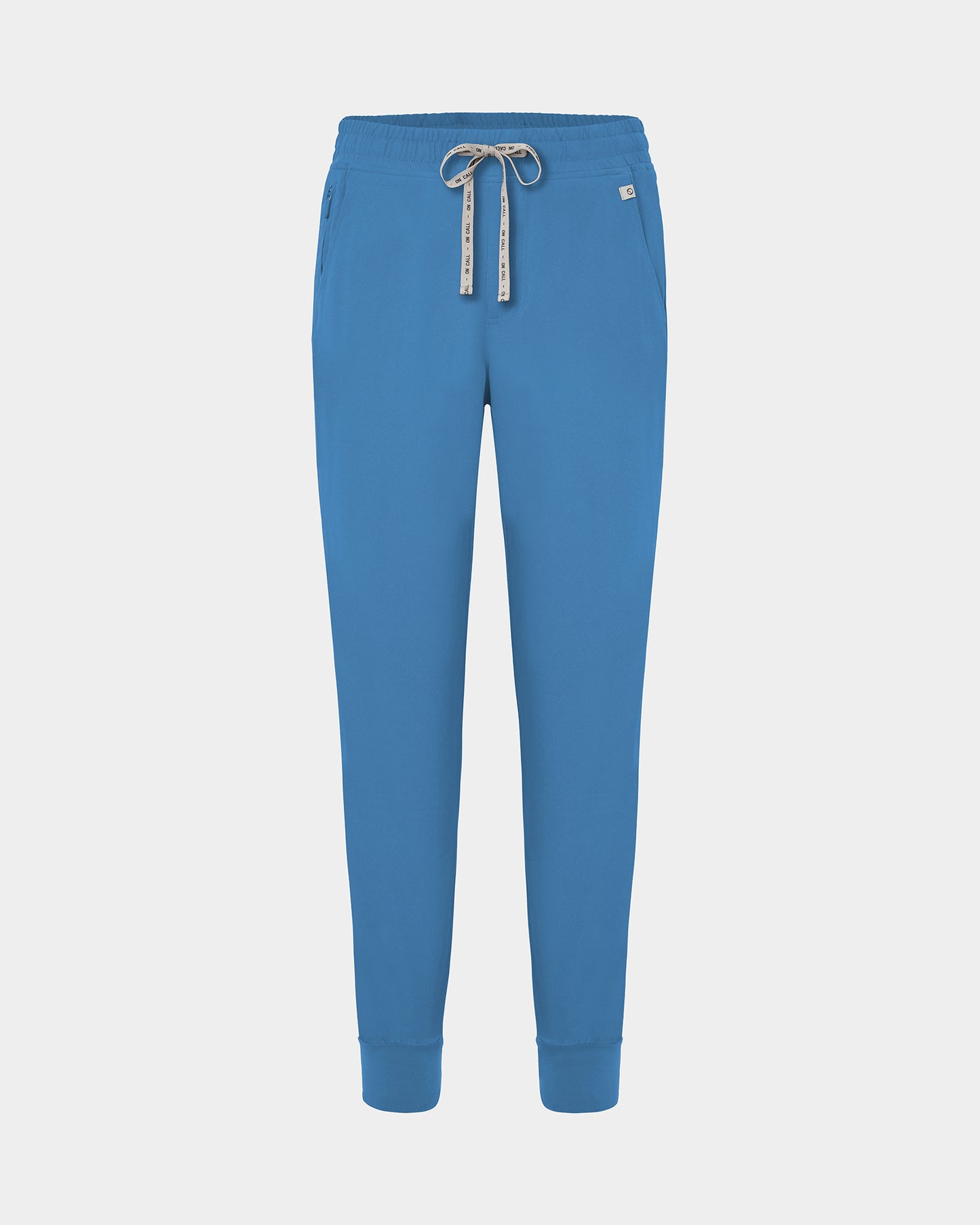 Bright blue jogger scrub pants with a logo drawstring, ankle cuffs, and a small white logo on the left hip, shown against a light gray background.