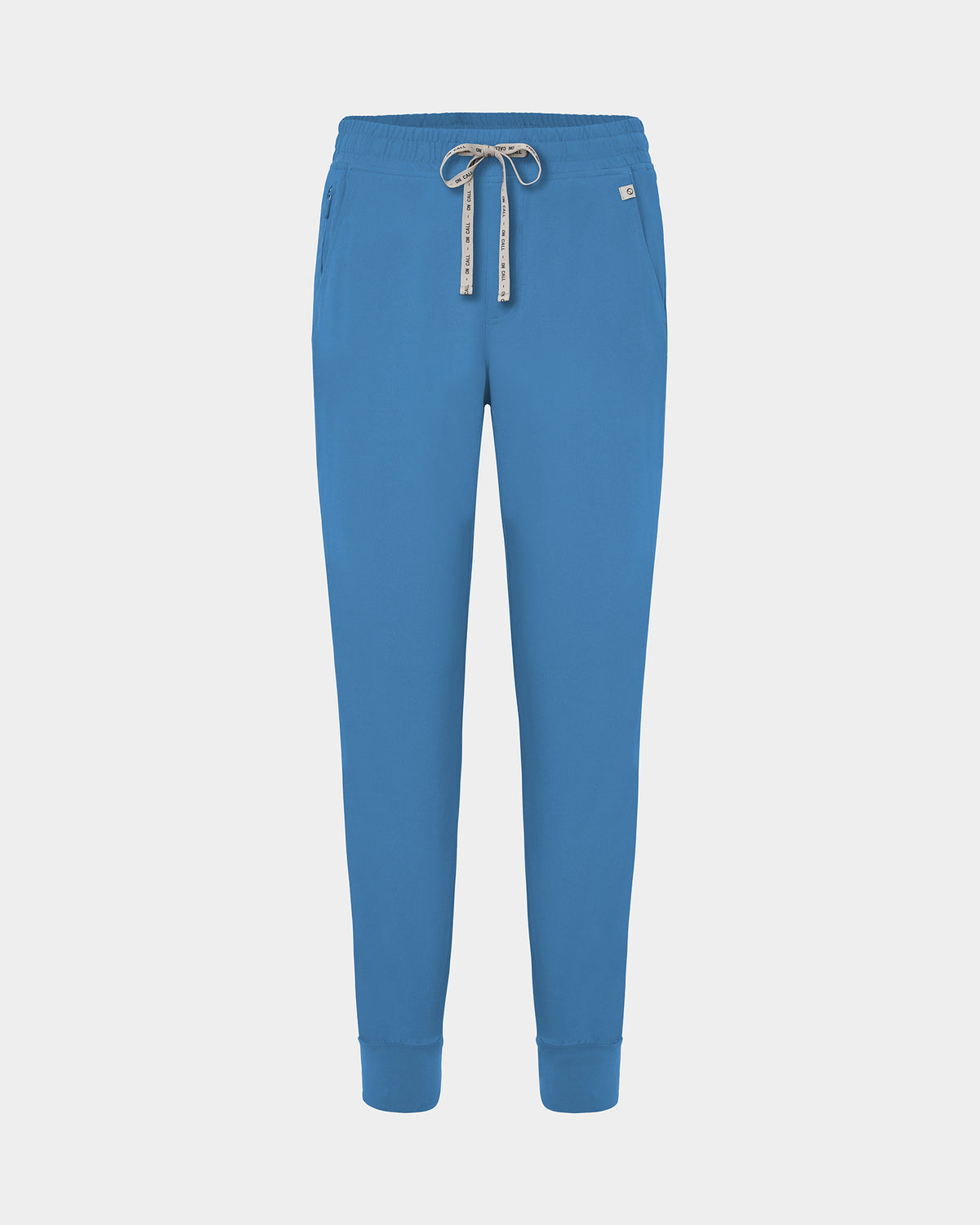 Bright blue jogger scrub pants with a logo drawstring, ankle cuffs, and a small white logo on the left hip, shown against a light gray background.
