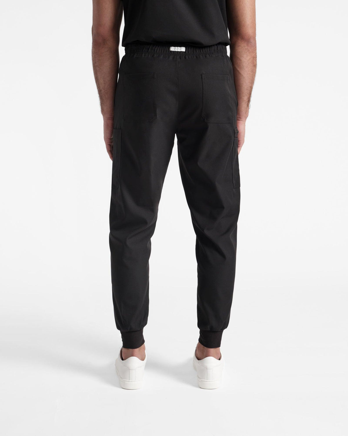 Back side view of men's black cargo jogger scrub pants.