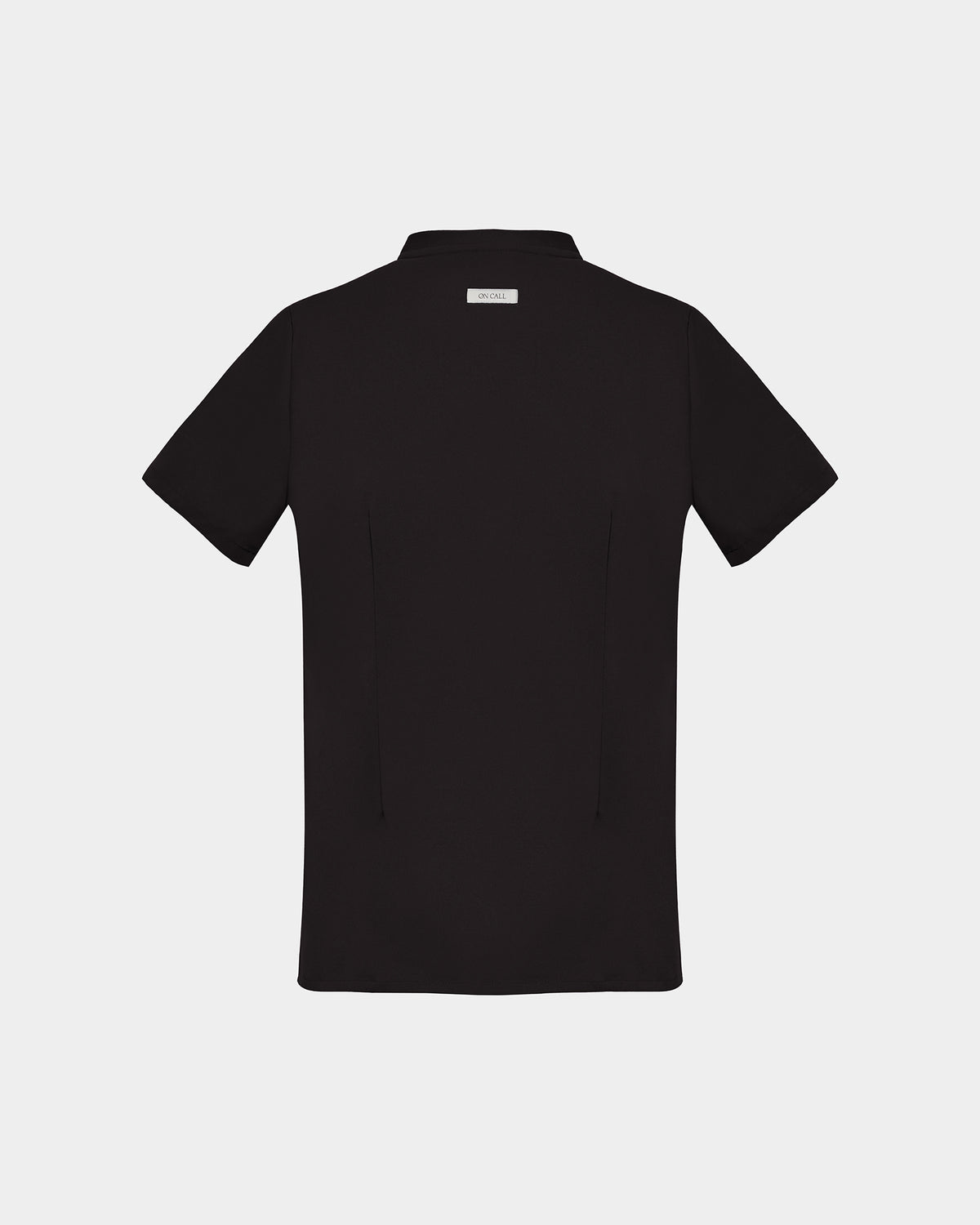 A black short-sleeve scrub shirt with a logo label under the collar, shown from the back on a light gray background.