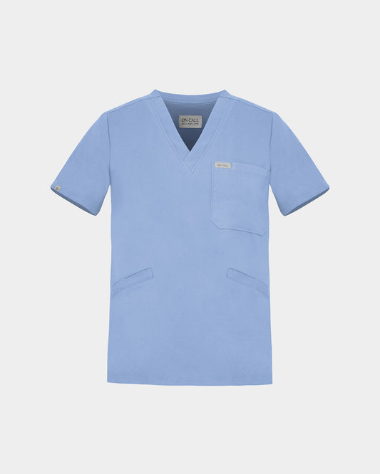 A light blue scrub top with a V-neck, short sleeves, a chest pocket, and two lower front pockets, shown on a light gray background.