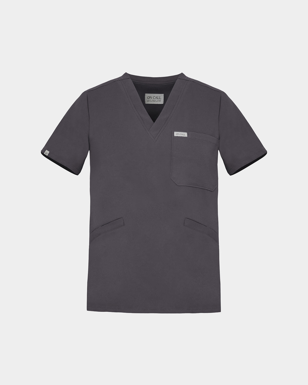 A dark grey V-neck scrub top with short sleeves, a chest pocket, and two lower front pockets, shown on a light gray background.