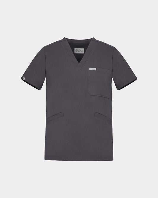 A dark grey V-neck scrub top with short sleeves, a chest pocket, and two lower front pockets, shown on a light gray background.