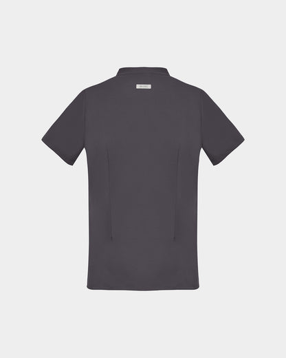 A dark gray short-sleeve scrub shirt shown from the back, featuring two subtle darts and a small rectangular brand label at the collar, set against a solid light gray background.