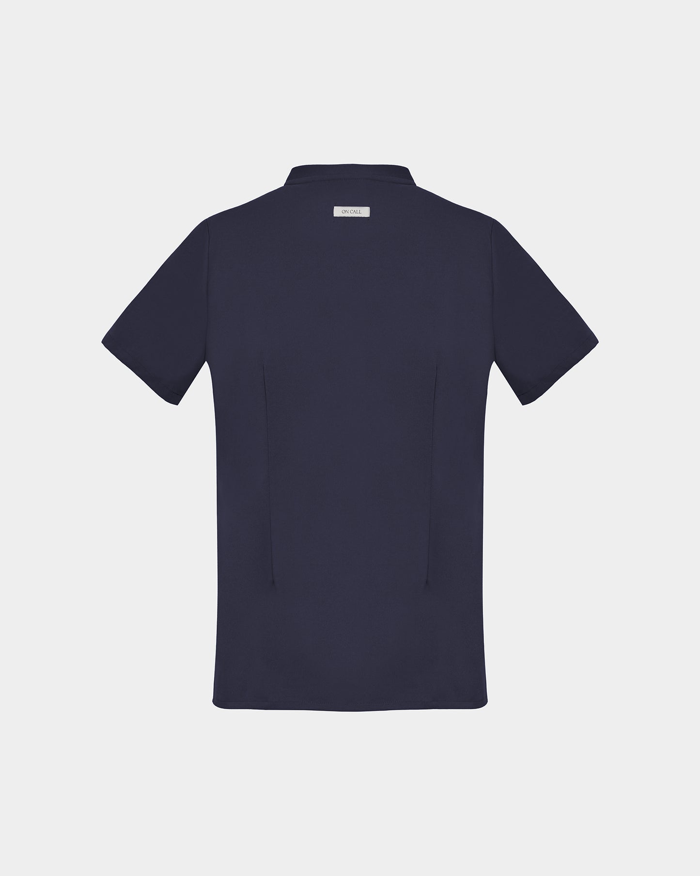 A dark navy short-sleeve scrub shirt shown from the back, featuring two subtle darts, centered on a light gray background.
