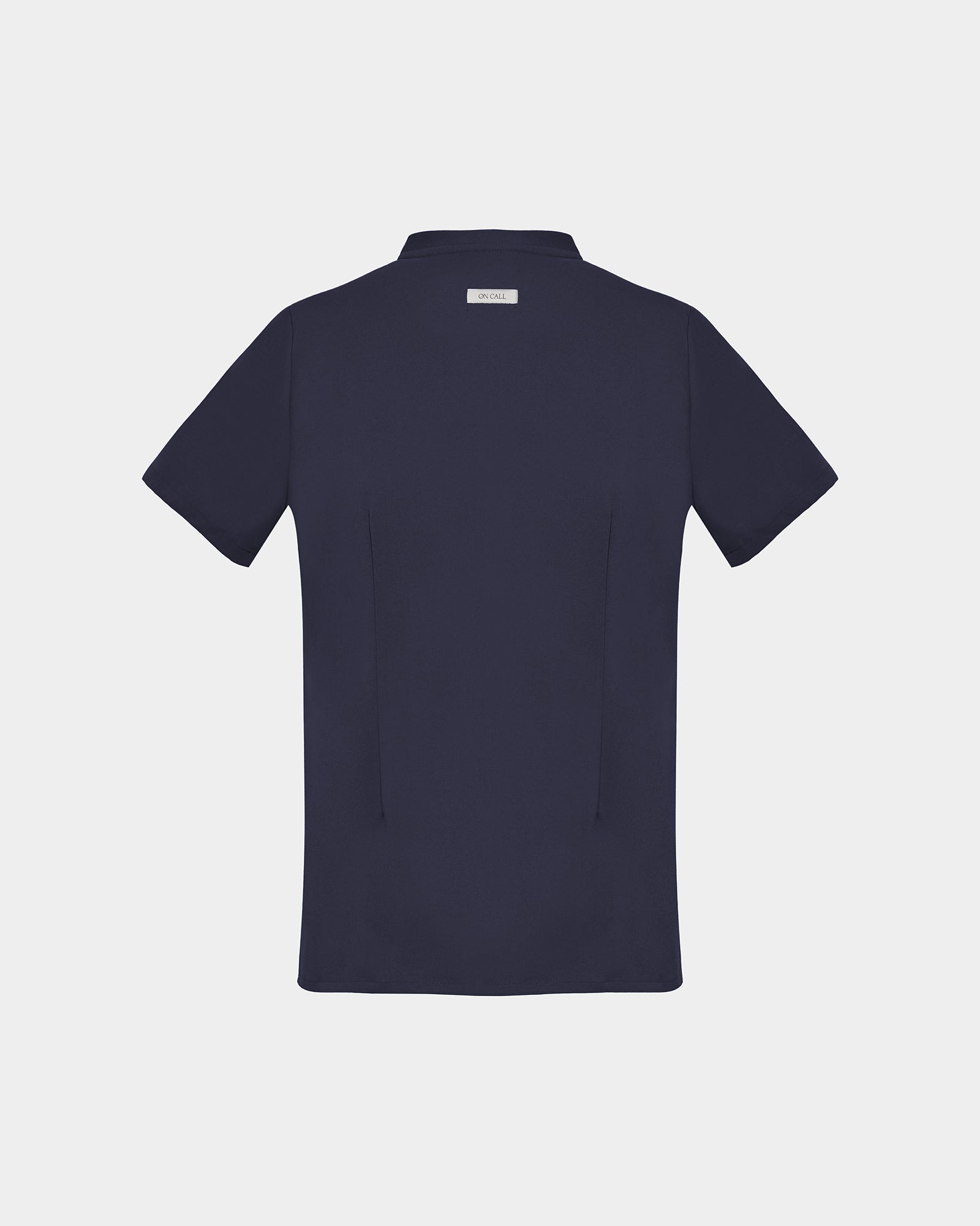 A dark navy short-sleeve scrub shirt shown from the back, featuring two subtle darts, centered on a light gray background.