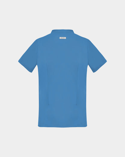 A short-sleeve scrub shirt in a solid bright blue color, featuring two subtle darts, shown from the back against a light gray background.