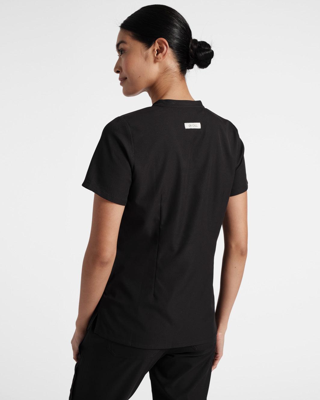Back view of black scrub top with dart detailing.